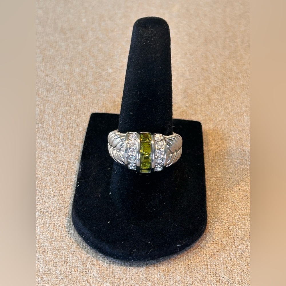 Elegant cocktail ring featuring peridot colored stones offset with clear stones​